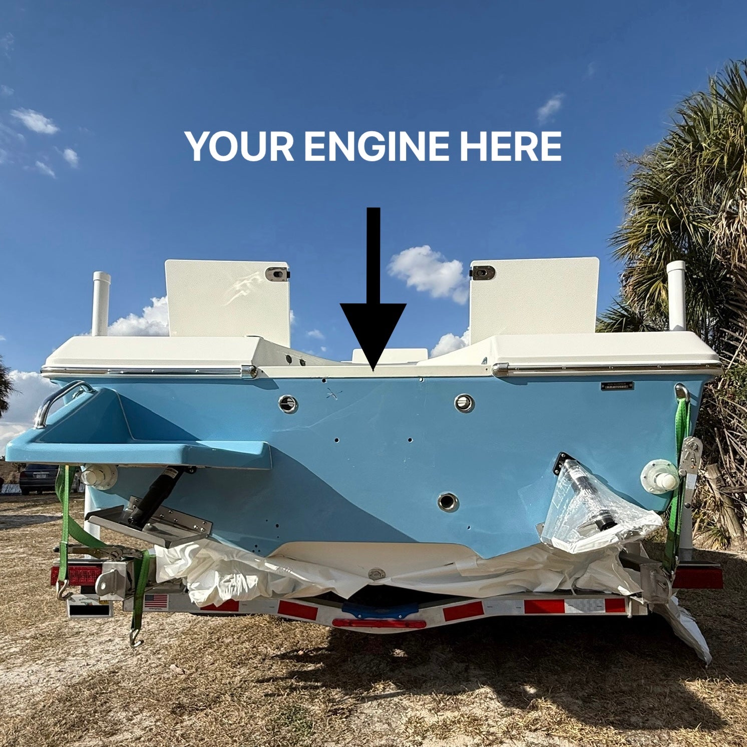 Back view of a boat with space for an engine installation, against a clear blue sky.